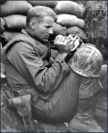 In the midst of the Korean War, this solider cares for a newborn kitten. 